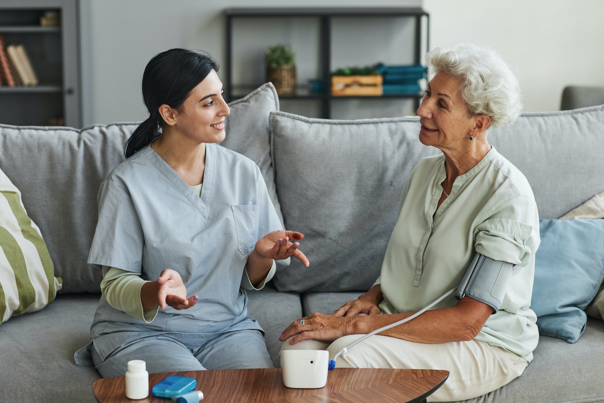 young-nurse-talking-to-senior-woman-in-retirement-home.jpg